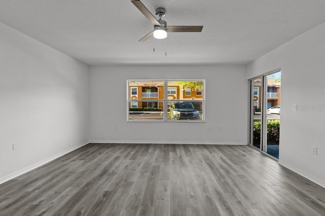 spare room with ceiling fan and light wood-type flooring