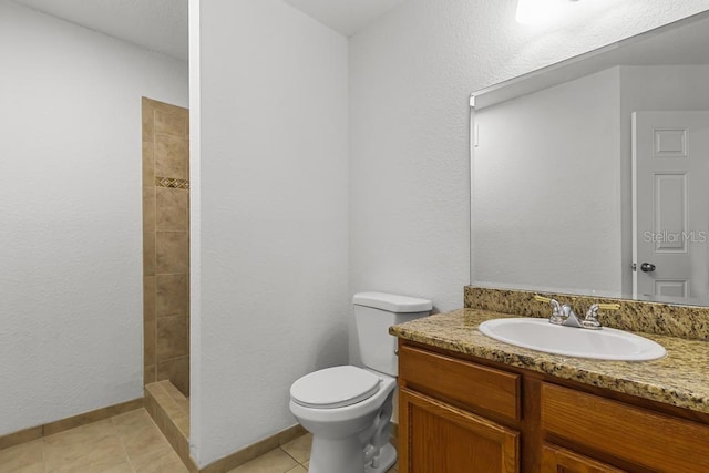 bathroom featuring vanity, toilet, and tile flooring