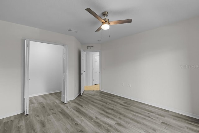 unfurnished bedroom with a closet, light hardwood / wood-style flooring, and ceiling fan