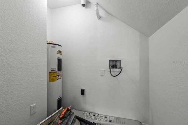 interior space featuring water heater and a textured ceiling