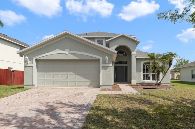 view of front of property with a front yard and a garage