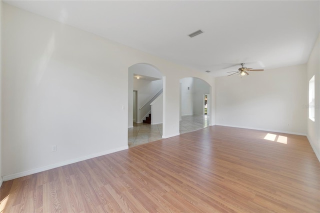 unfurnished room with ceiling fan and light wood-type flooring