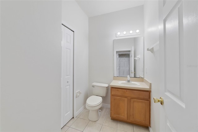 bathroom with tile flooring, toilet, and vanity with extensive cabinet space