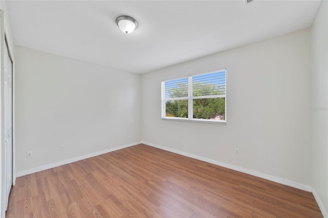 unfurnished room with light hardwood / wood-style floors