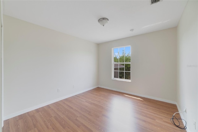 spare room with light hardwood / wood-style flooring