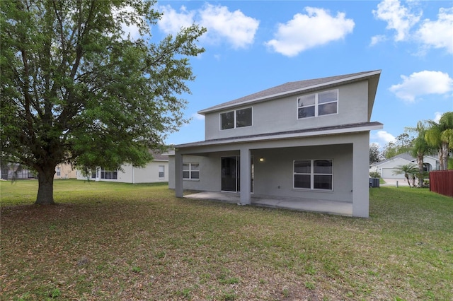 back of property with a yard and a patio area