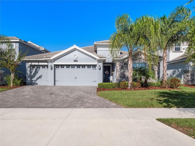 view of front of property featuring a garage and a front lawn