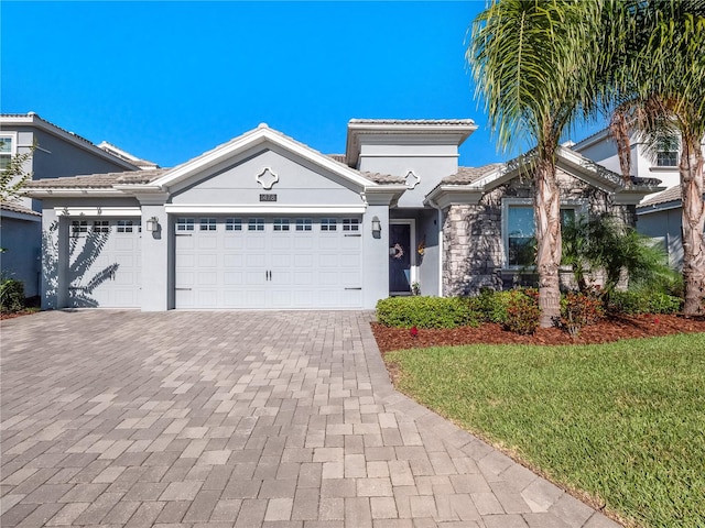 view of front of house with a garage and a front lawn