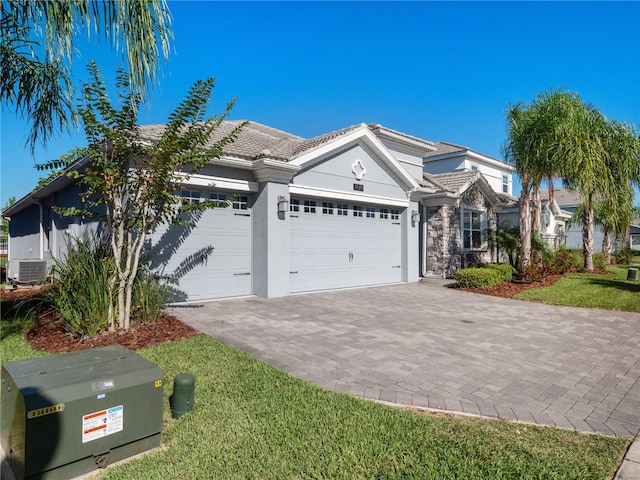 view of front of property with a garage and central air condition unit