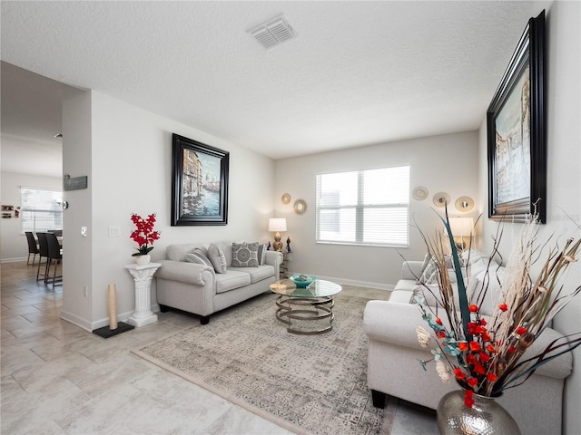 tiled living room with a textured ceiling