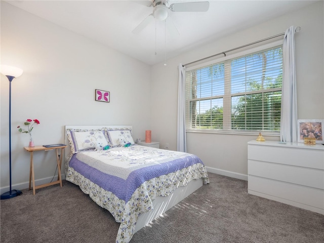 bedroom featuring ceiling fan and dark carpet