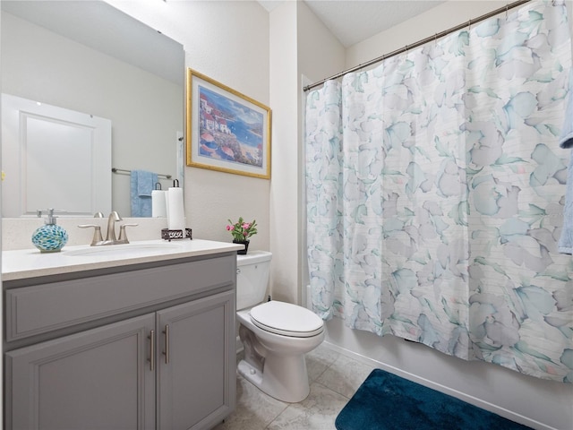 full bathroom featuring toilet, tile floors, vanity, and shower / tub combo with curtain