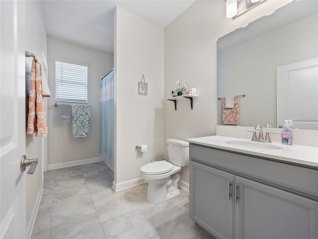 bathroom with toilet, tile flooring, and vanity