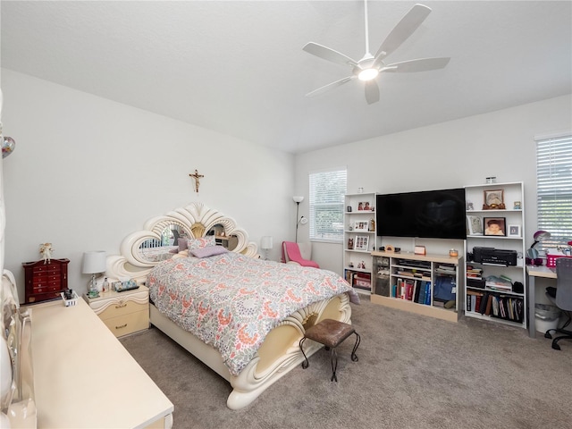 bedroom featuring dark colored carpet, ceiling fan, and multiple windows