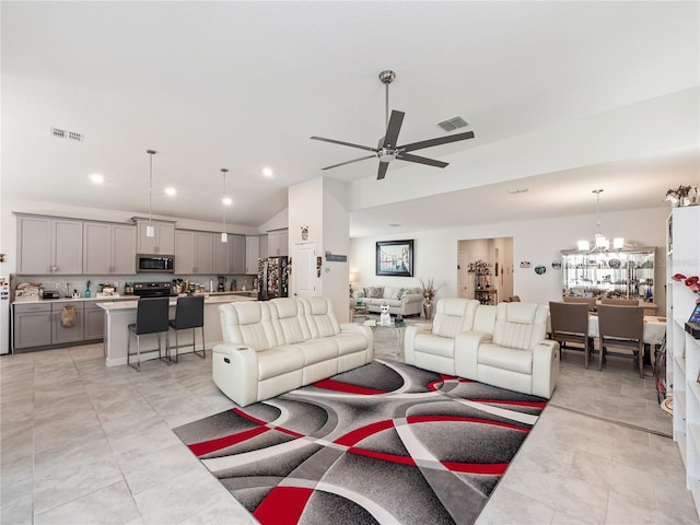 living room featuring ceiling fan with notable chandelier, vaulted ceiling, and light tile flooring