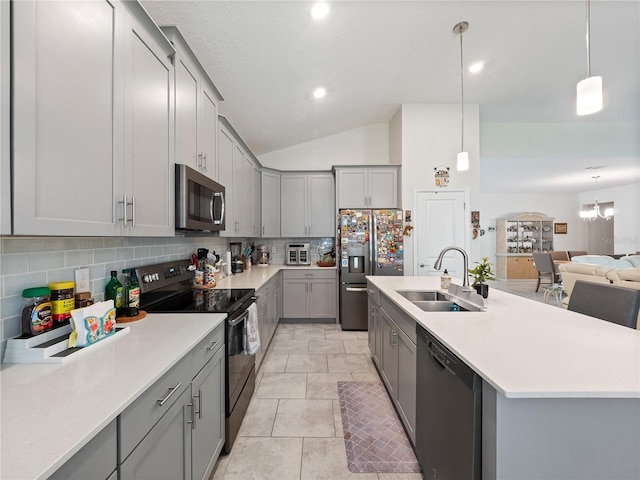 kitchen with backsplash, gray cabinets, sink, and stainless steel appliances