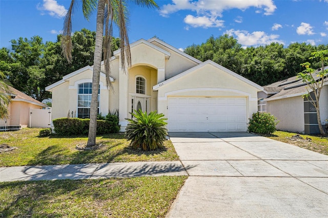 view of front facade with a garage and a front yard