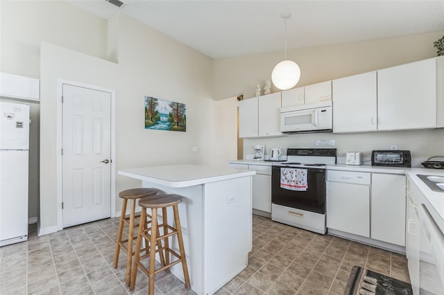 kitchen featuring white cabinets, a kitchen breakfast bar, white appliances, and light tile floors