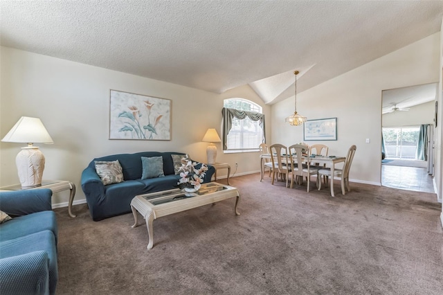 carpeted living room featuring ceiling fan and vaulted ceiling