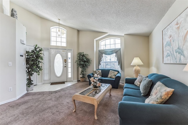 carpeted living room featuring a textured ceiling and a towering ceiling