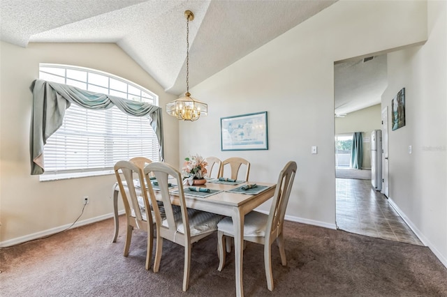 dining room featuring a healthy amount of sunlight, dark colored carpet, vaulted ceiling, and a notable chandelier