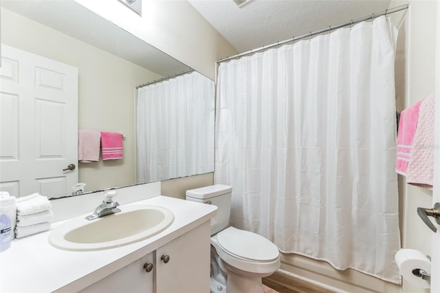 full bathroom with a textured ceiling, shower / tub combo with curtain, toilet, vanity, and hardwood / wood-style flooring