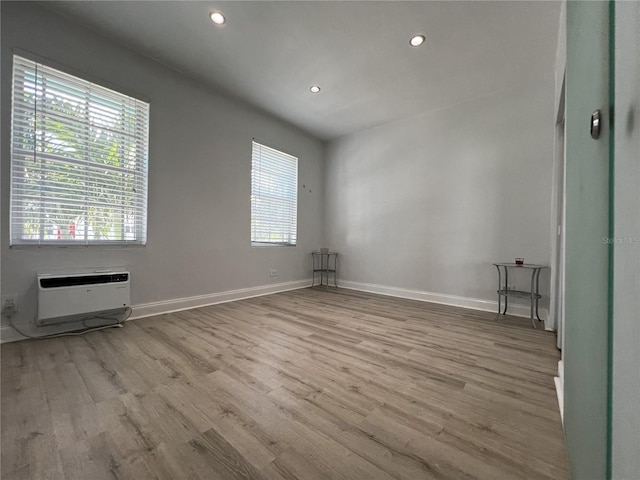 spare room with a healthy amount of sunlight and wood-type flooring