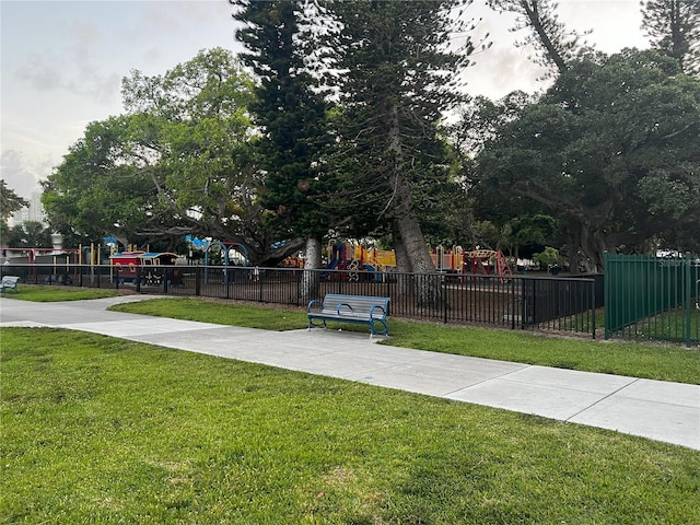 view of property's community with a playground and a lawn