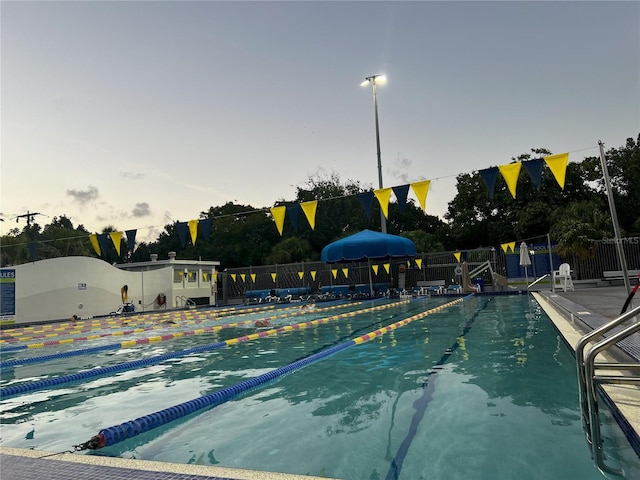 view of pool at dusk