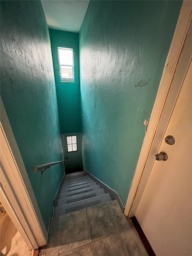 stairs with dark tile flooring