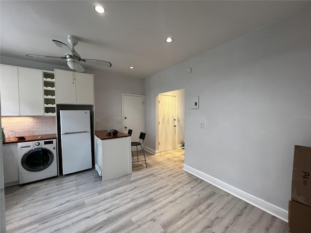 kitchen featuring ceiling fan, white cabinets, light wood-type flooring, white refrigerator, and washer / clothes dryer