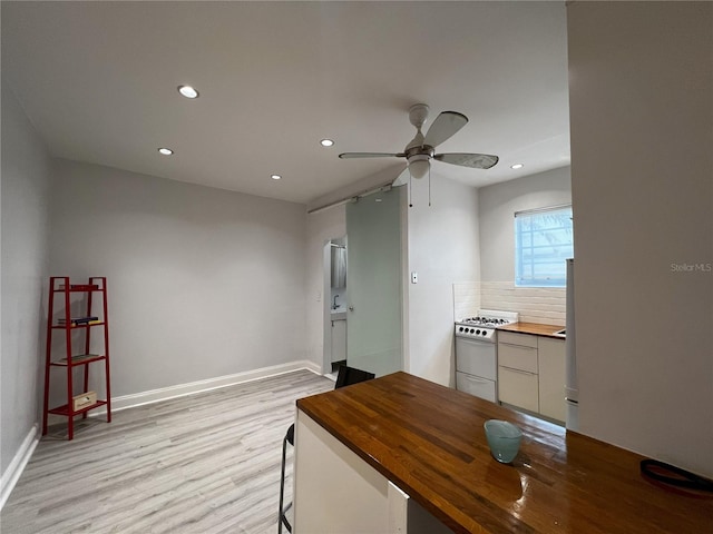 interior space with ceiling fan and light wood-type flooring