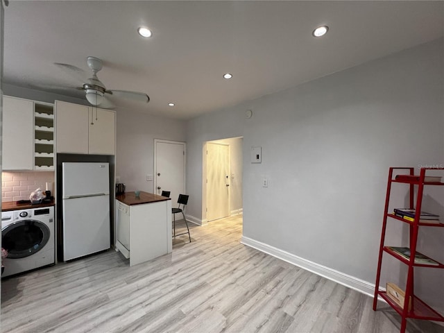 laundry room with light hardwood / wood-style flooring, ceiling fan, and washer / clothes dryer