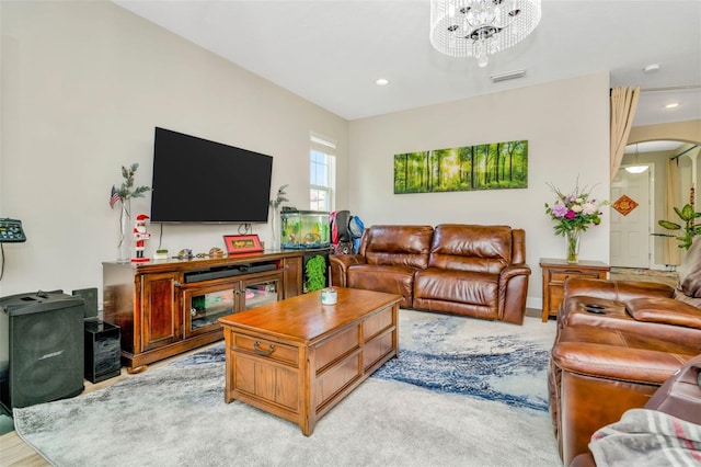 living room featuring light hardwood / wood-style floors and an inviting chandelier