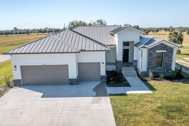 view of front of house featuring a garage and a front lawn