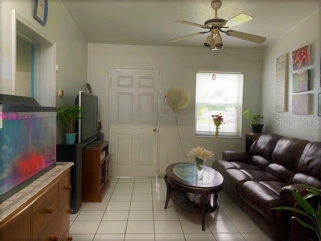 tiled living room featuring ceiling fan