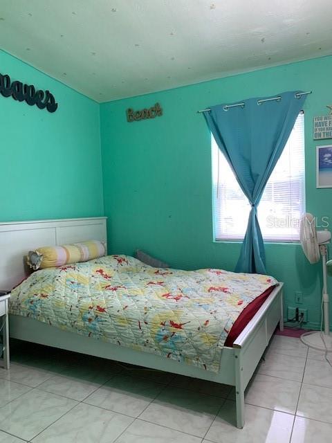 bedroom with light tile flooring