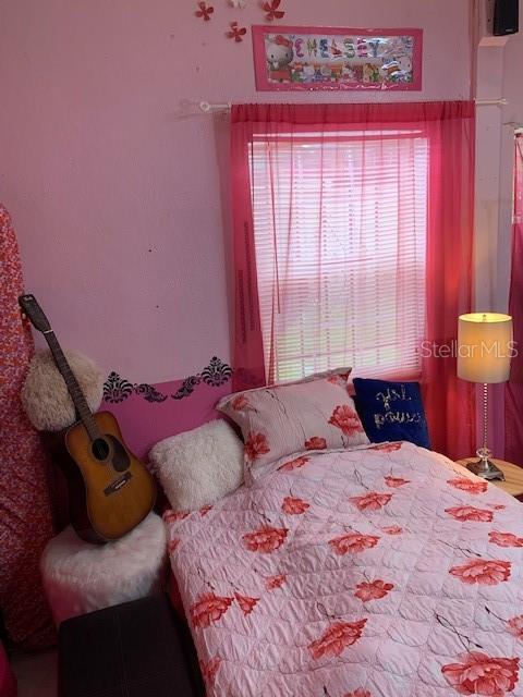 bedroom featuring multiple windows