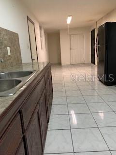 interior space with sink and light tile floors