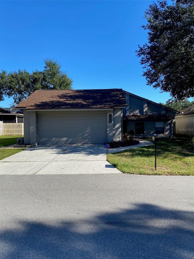 view of front of house with a garage and a front yard