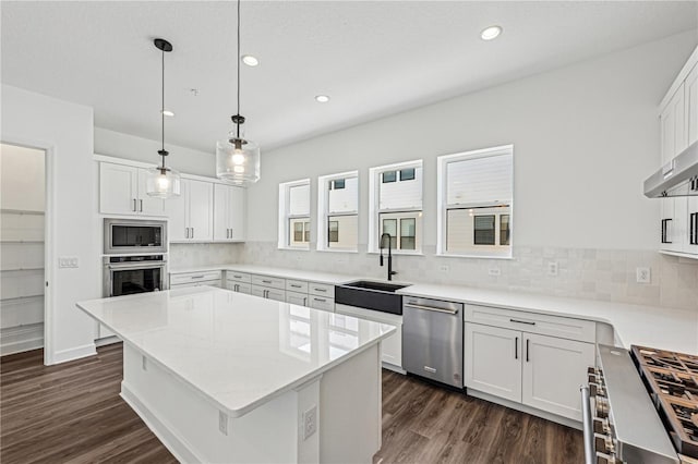 kitchen featuring white cabinets, stainless steel appliances, and a kitchen island