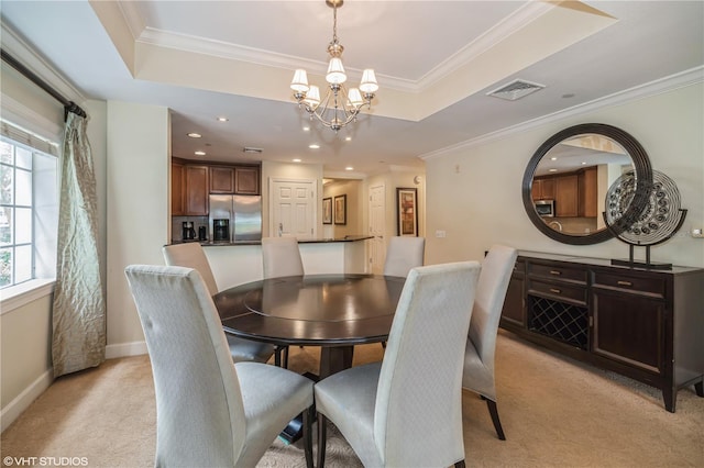 dining area featuring a raised ceiling, light carpet, a chandelier, and crown molding