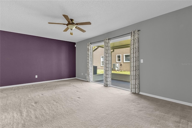 empty room with a textured ceiling, ceiling fan, and carpet