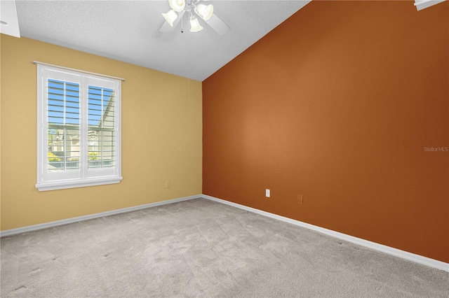 spare room featuring ceiling fan, carpet flooring, and a textured ceiling