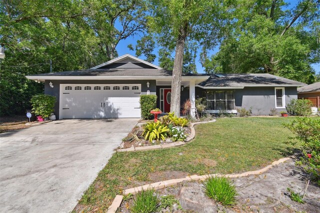 ranch-style home with a front lawn and a garage