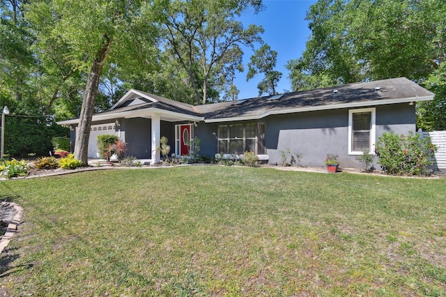 ranch-style house featuring a front lawn and a garage