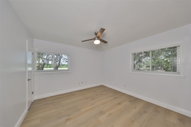 spare room featuring light hardwood / wood-style floors and ceiling fan