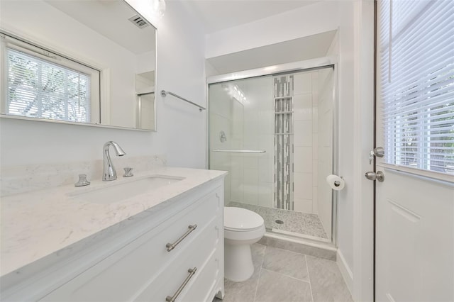 bathroom with an enclosed shower, vanity, toilet, and tile flooring