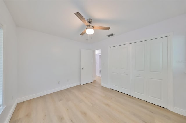 unfurnished bedroom with a closet, light hardwood / wood-style flooring, and ceiling fan