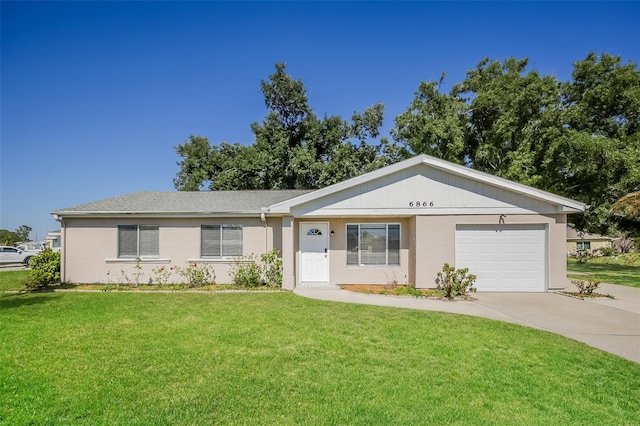 ranch-style house featuring a garage and a front lawn